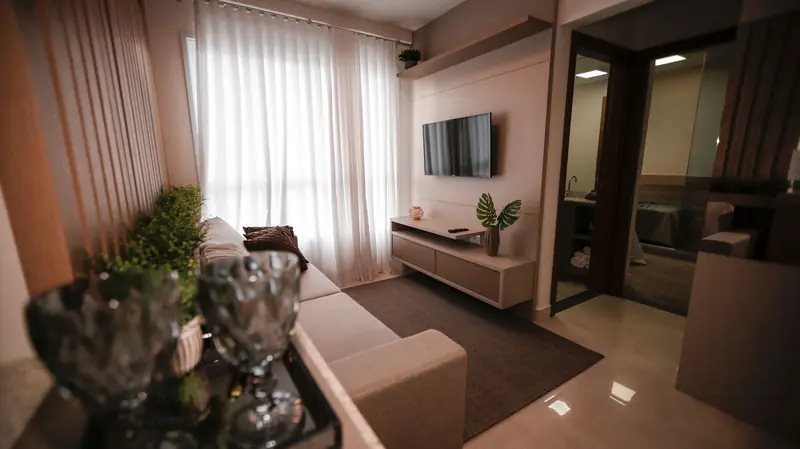 A contemporary living room featuring a sleek TV setup, comfortable sofa, and elegant decor, perfect for relaxing at home