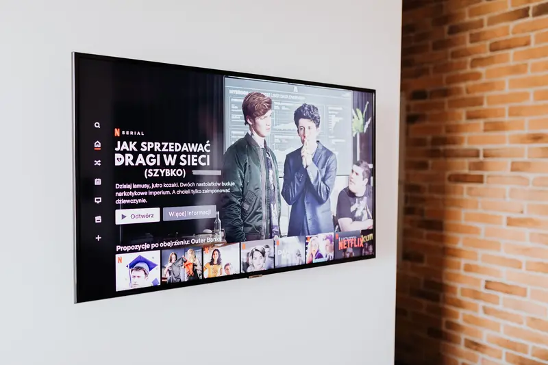 Smart TV displaying streaming content in modern living room setting with exposed brick wall