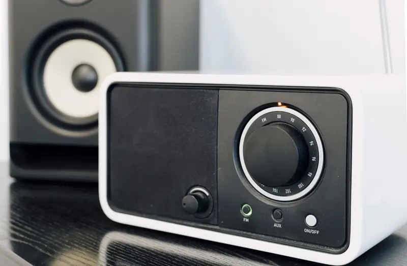 Close-up of a modern radio and speaker setup, showcasing audio equipment design
