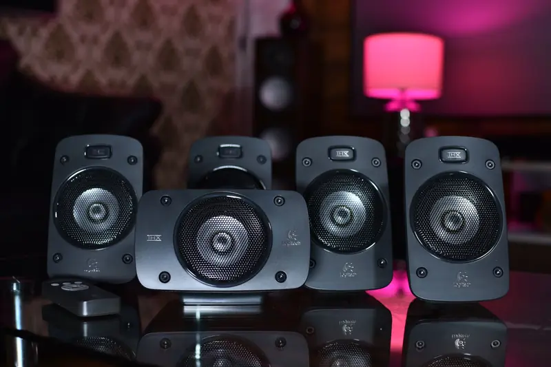 A close-up of a surround sound speaker system with remote, perfect for modern home entertainment