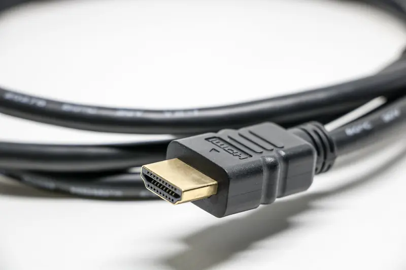 A detailed image of a black HDMI cable with gold connectors on a white background