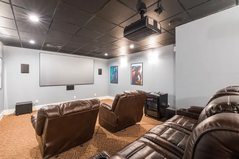 Cozy home theater setup with plush leather recliners and modern audiovisual equipment